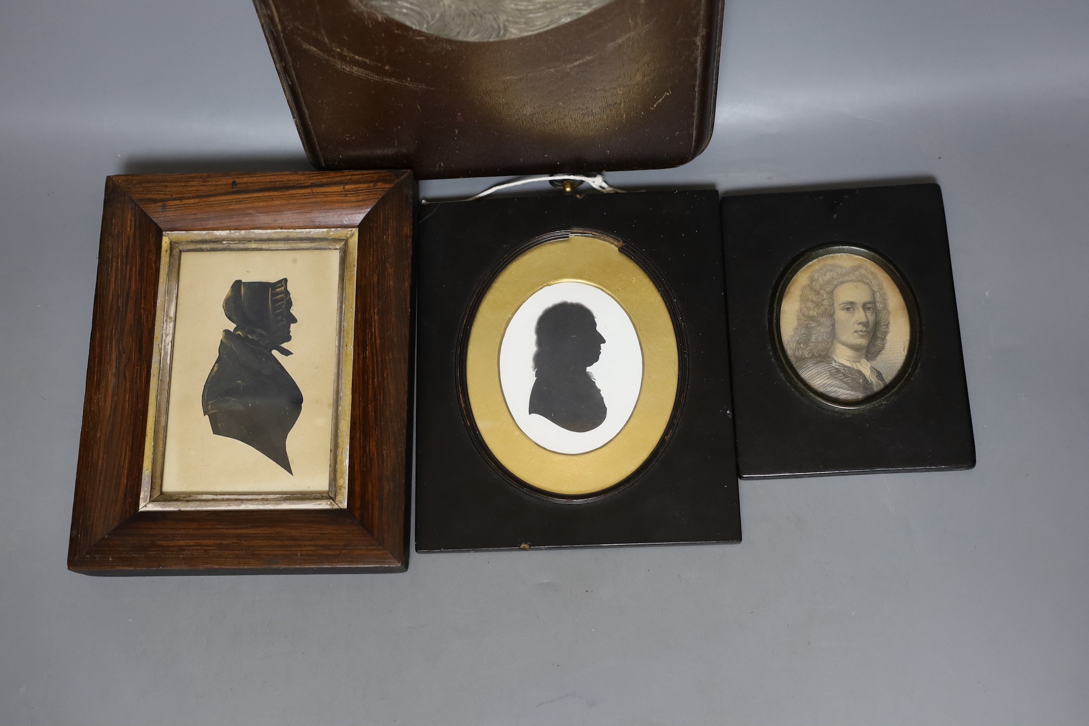 Two Victorian silhouette portraits, a printed monochrome bust, all framed together, with an early 20th century German relief of a borzoi, 33 x 19cm